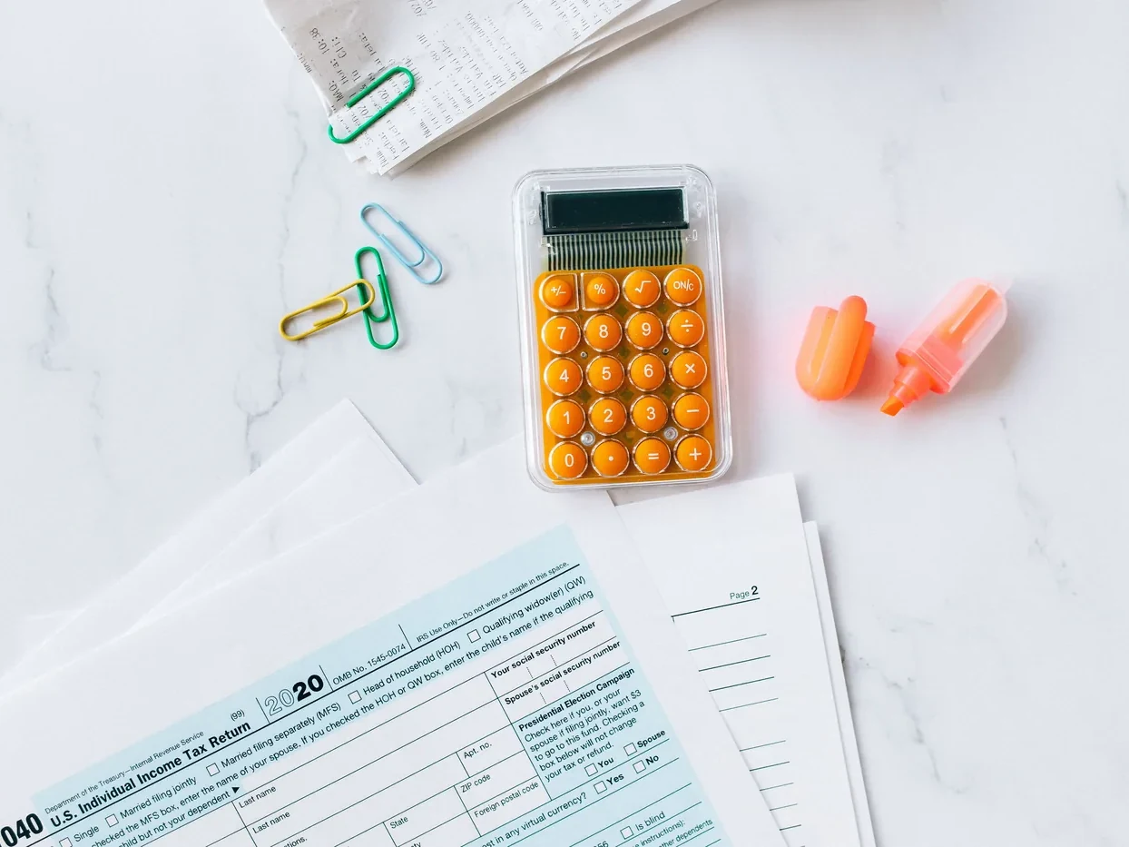 Calculator and financial paperwork laid out for review