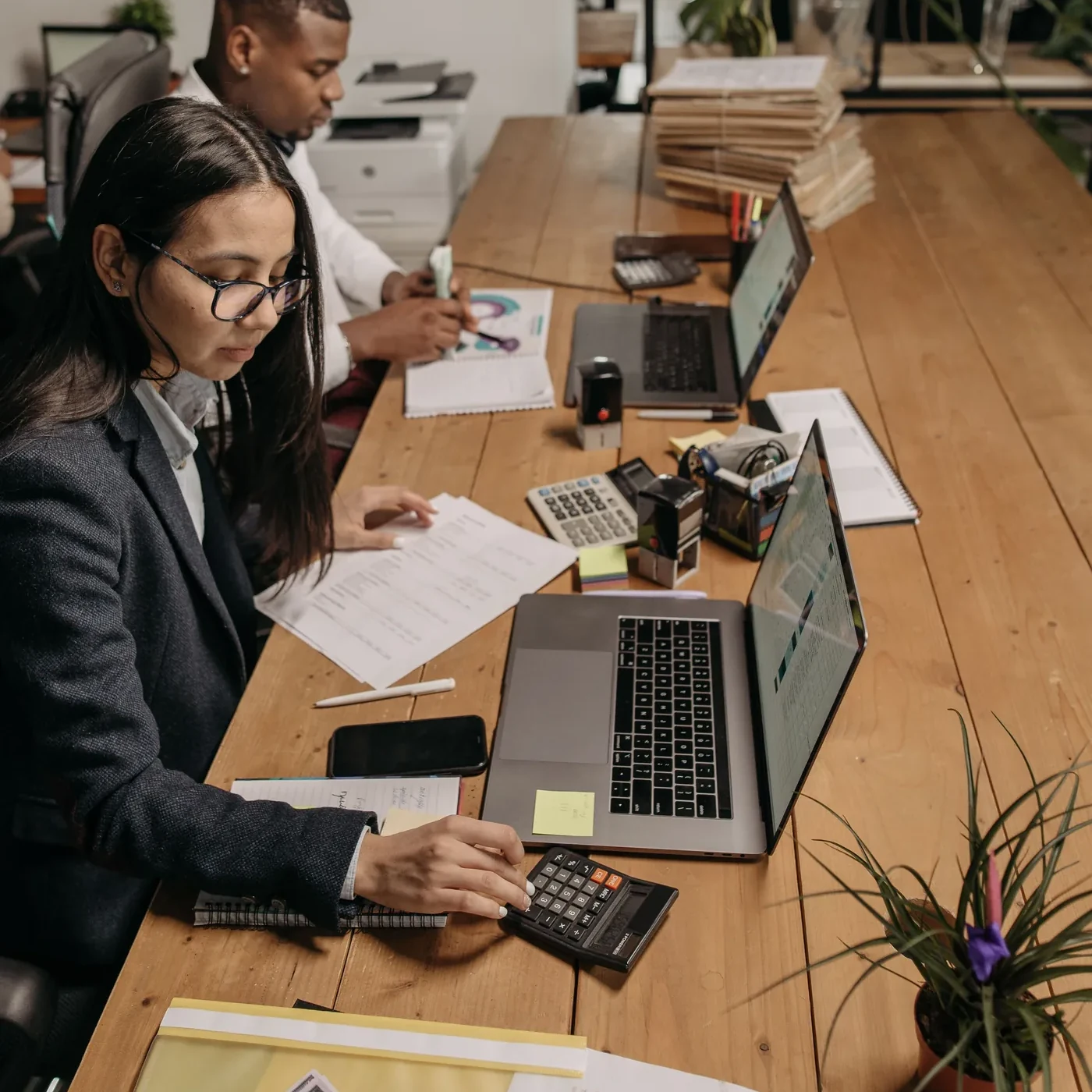 Workspace with financial tools and laptops